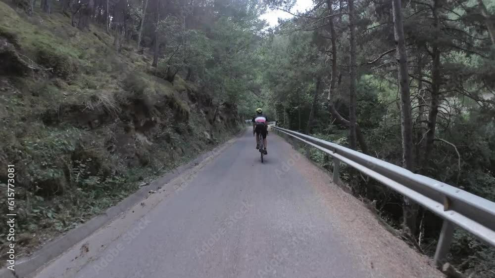 Road cyclist speeding down a mountain road.Road cycling Road cyclist speeding down a mountain road.Road cycling