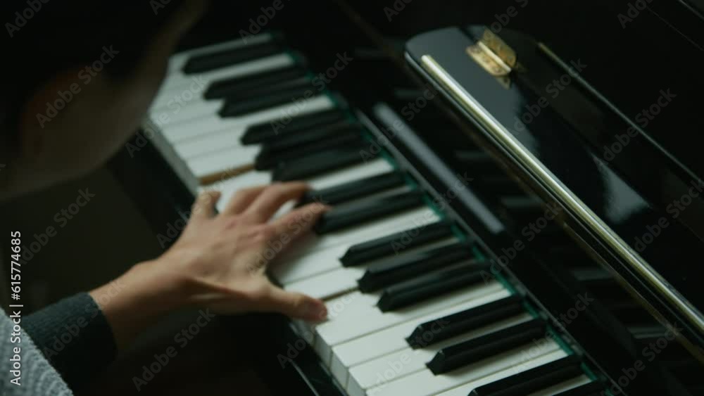 female playing piano in her home. Cinematic setting. classical music in slow motion.
