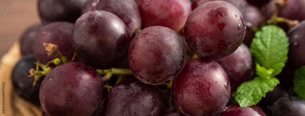 Delicious bunch of grapes fruit on a plate over wooden table background. Delicious bunch of grapes fruit on a plate over wooden table background.
