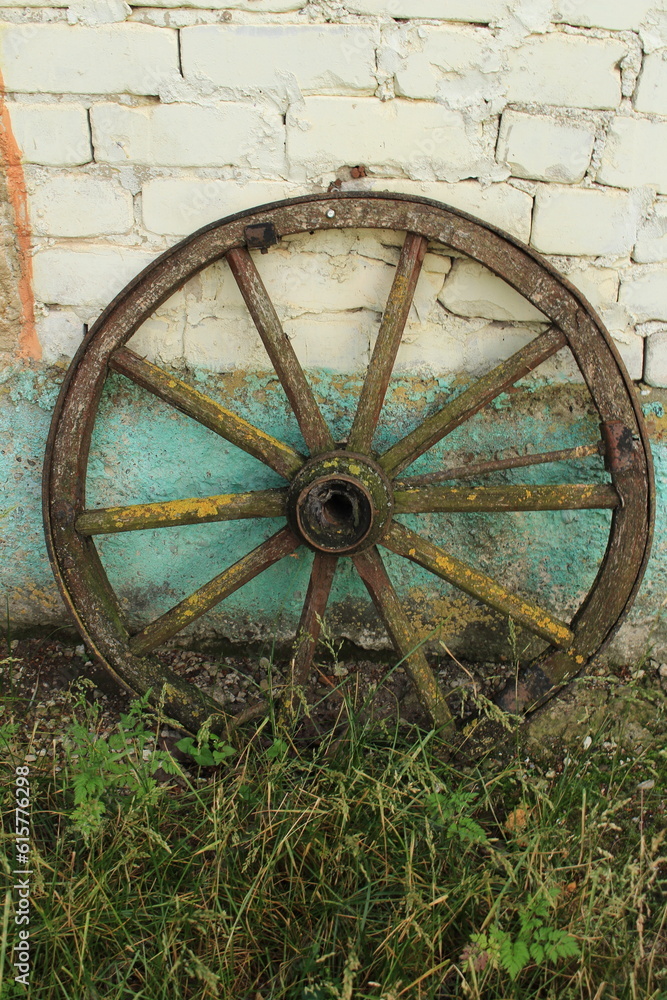 A wooden wheel on grass