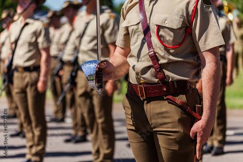 Australian army soldier with sword drawn for Freedom of Entry ceremony beside troops