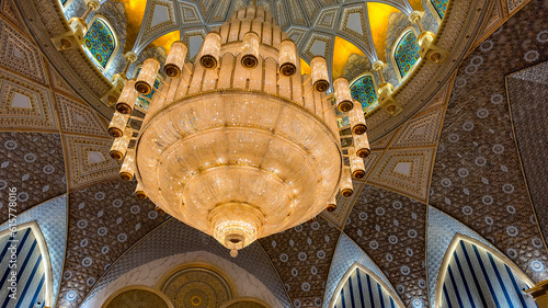 a beautiful chandelier hangs in the presidential palace Qasr al watan photo