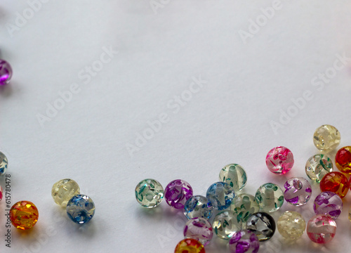 handicraft items, jewelry, beads, DIY background. Plastic acrylic glass beads of different shapes and colors for making brooches, pendants, collars. Blur effect. Weak focus.