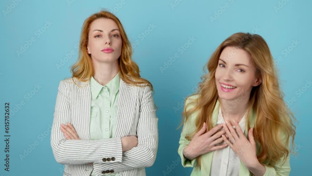 Laughing friends, excited woman man looking at camera. Two women sister, businesswoman smiling having fun, expressive laughter for humor, good mood, comic emotion. Studio isolated on blue background. Laughing friends, excited woman man looking at camera. Two women sister, businesswoman smiling having fun, expressive laughter for humor, good mood, comic emotion. Studio isolated on blue background.