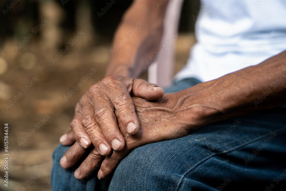 Fototapeta premium Close up of elderly oldman hands on wooden table.