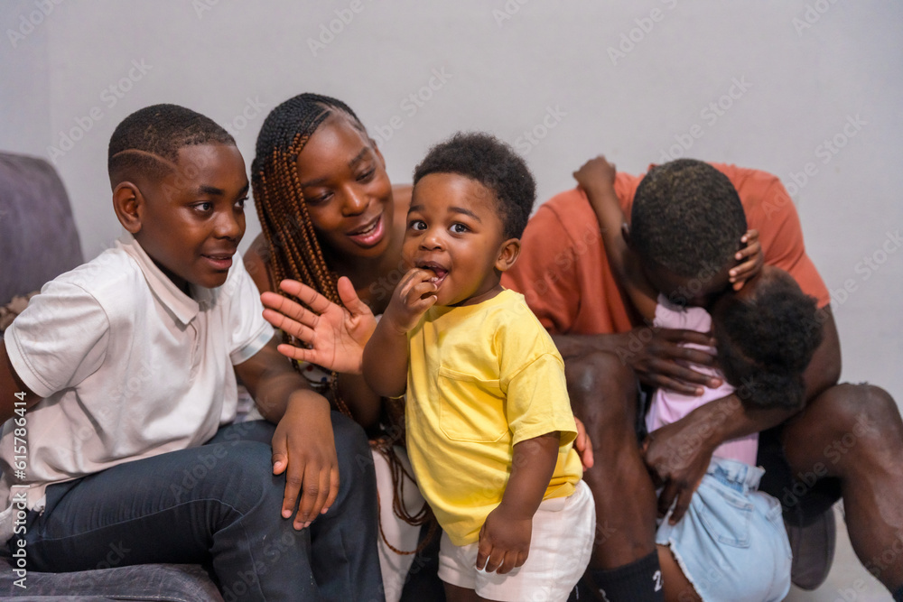 African black ethnic family with children on the sofa in their home