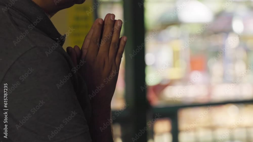 Man in prayer, hands joined together, expressing devotion and reverence Man in prayer, hands joined together, expressing devotion and reverence