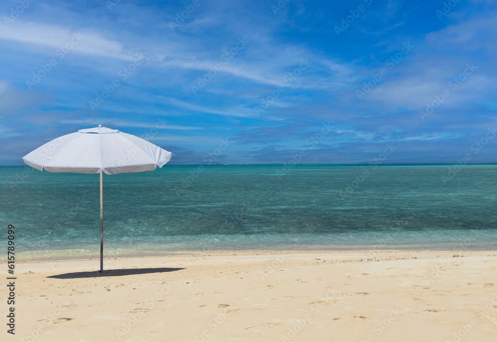 Summer tropical with white umbrella on the beach with blue sky background Summer tropical with white umbrella on the beach with blue sky background