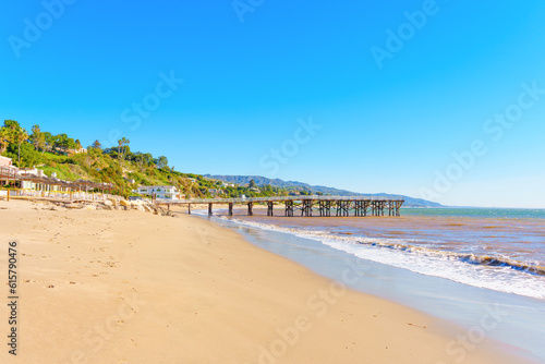 Malibu Beachscape: Wooden Pier, Sandy Shore and Coastal Homes © Katie Chizhevskaya