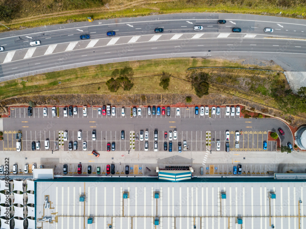 overhead view of highway beside busy hardware store with car parking overhead view of highway beside busy hardware store with car parking