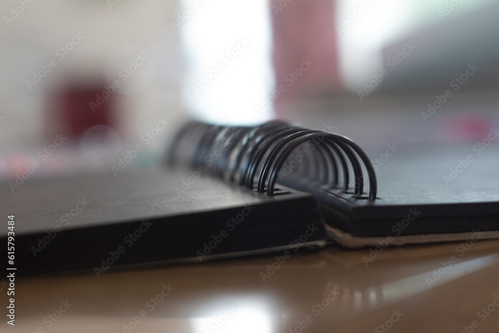 black notebook on a metal spring close-up black notebook on a metal spring close-up