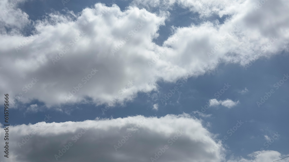 Blue cloudy sky texture. Natural sky composition Blue cloudy sky texture. Natural sky composition