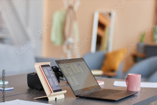 Background image of computer devices on workplace, smartphone and laptop IT design concept, copy space