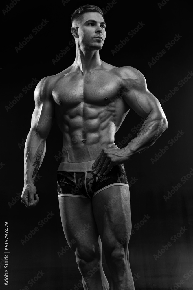 Bodybuilder showing off his perfect low fat body without clothes in studio Bodybuilder showing off his perfect low fat body without clothes in studio