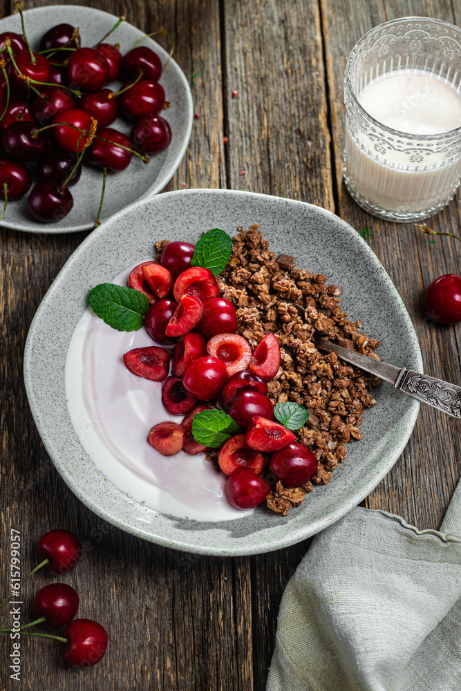 Granola with yogurt and cherries in a bowl
