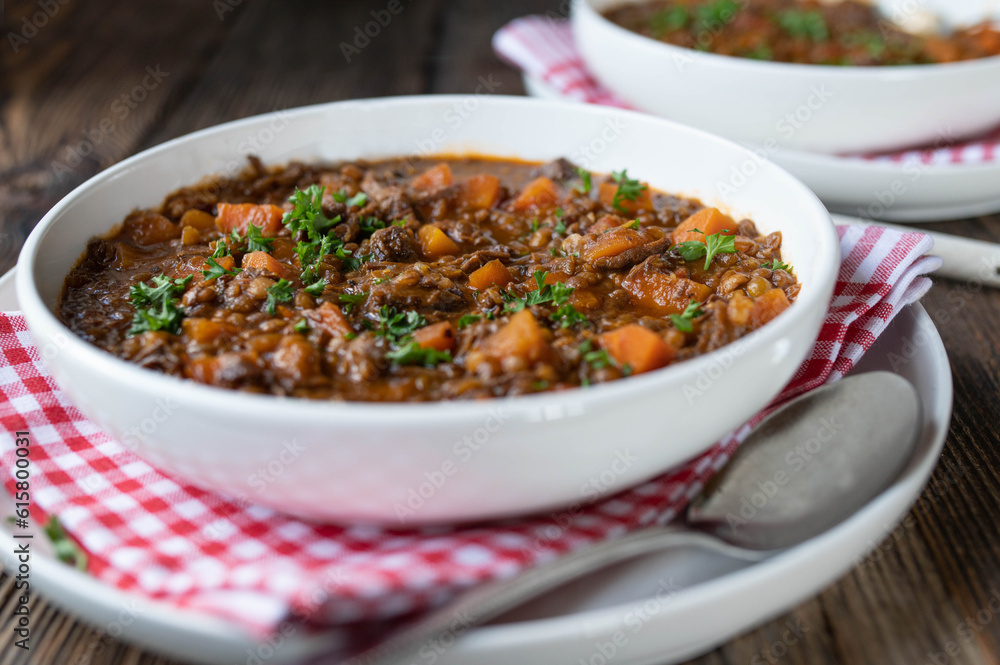 Stew with beef meat, lentils and vegetables on a plate Stew with beef meat, lentils and vegetables on a plate