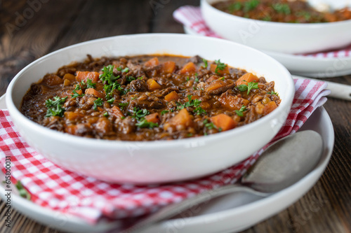 Stew with beef meat, lentils and vegetables on a plate