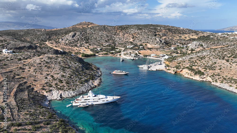 Aerial drone photo of small port of Schoinousa island a safe harbour to yachts and sail boats featuring small beach of Myrsini covered in Almirikia trees, Small Cyclades, Greece