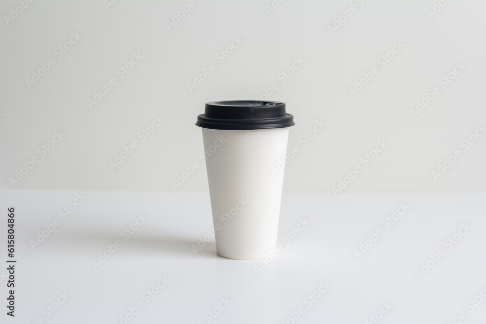 a white paper coffee cup with a lid without inscriptions stands on the table a white paper coffee cup with a lid without inscriptions stands on the table