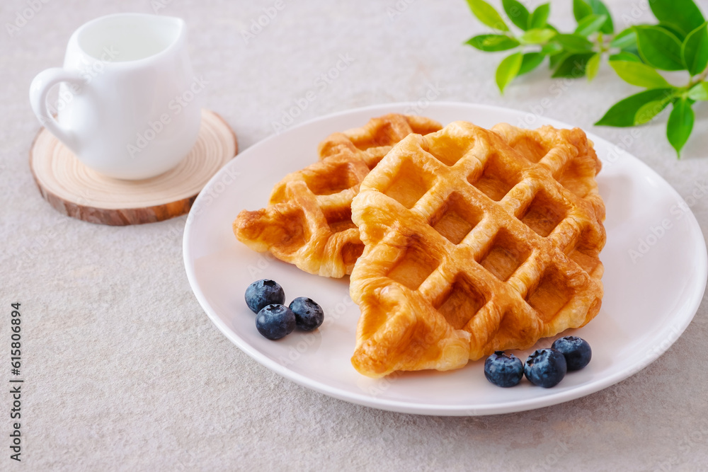 Croffle or croissant waffle with blueberries on plate Croffle or croissant waffle with blueberries on plate