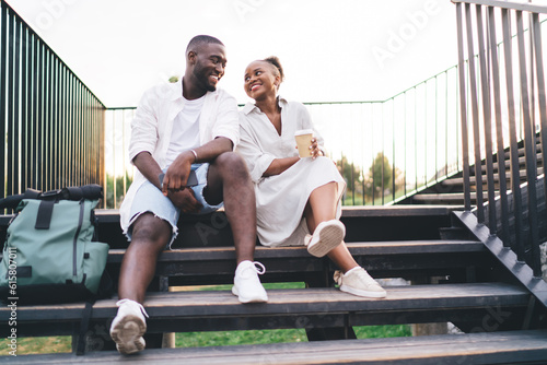 Smiling African American couple on park steps