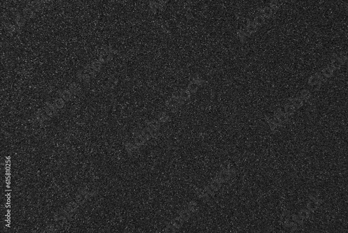 Fotografija Background filled with black particles.