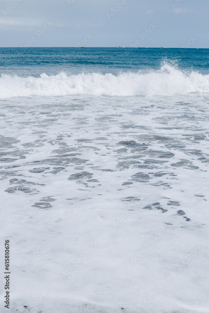 Textured sea foam. Wave on the beach