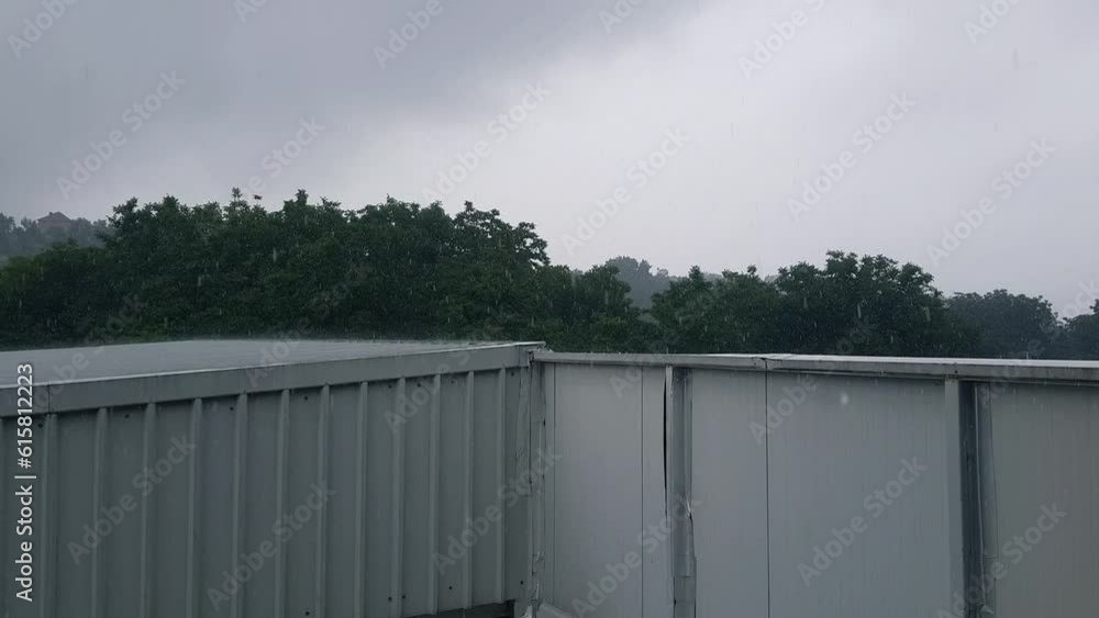 Heavy rain with wind falling on the metal factory roof Heavy rain with wind falling on the metal factory roof