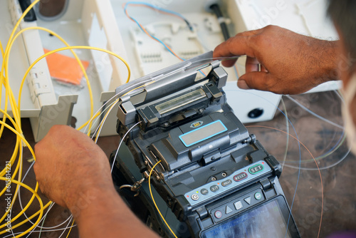 Technician working, fiber optic cable splicing and testing cables with optical power meter  photo