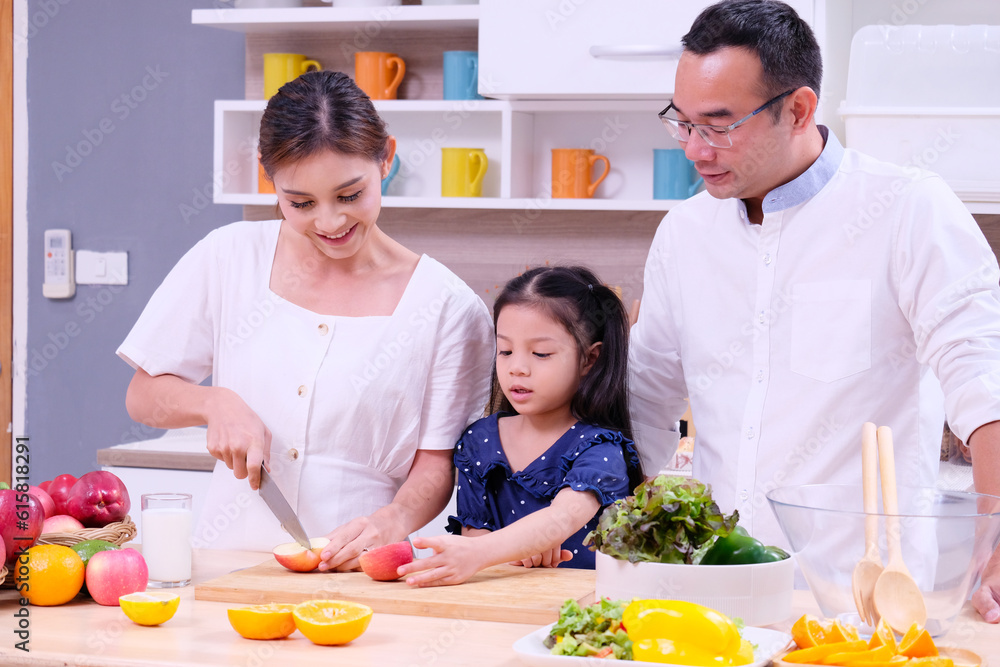 Family, father, mother, son cooking, happy smiling in the kitchen. Family, father, mother, son cooking, happy smiling in the kitchen.