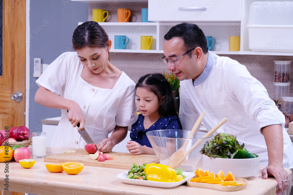 father and mother teaching children to cook happy smile family concept.