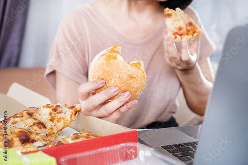 Fotobehang Binge Eating Disorder concept with woman over eating Fast Food Burgers and Pizza