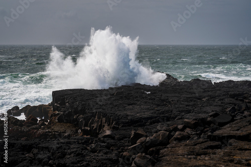 Stormy times at reykjanesbaer, reikjanes in iceland, waves spalshing on the cliffs 