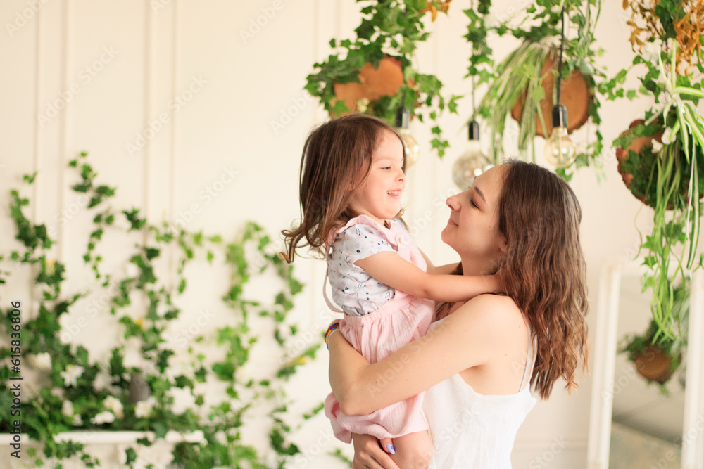 Beautiful mother and little daughter in the home interior. Baby. Motherhood. Beautiful mother and little daughter in the home interior. Baby. Motherhood.