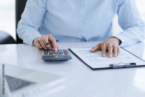 Businesswoman Accountant analyzing investment charts Invoice and pressing calculator buttons over documents. Accounting Bookkeeper Clerk Bank Advisor And Auditor