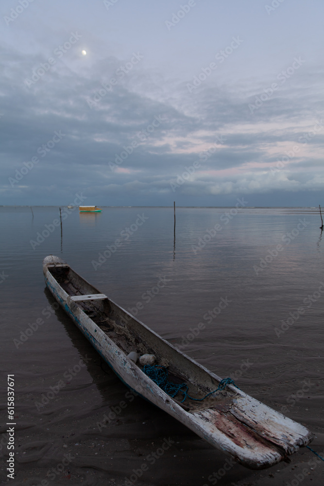 Rustic canoe at the sunset at Moreré, Bahia, Brazil Rustic canoe at the sunset at Moreré, Bahia, Brazil