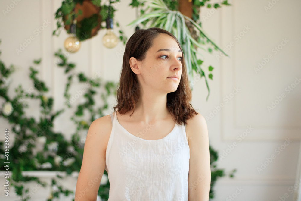 Happy young caucasian woman look in window distance thinking or dreaming, smiling optimistic millennial female renter feel overjoyed excited moving to new home, visualizing or imagining indoors