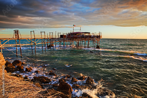 Rocca San Giovanni, Chieti, Abruzzo, Italy: landscape of the Adriatic sea coast at dawn with an ancient fishing hut trabocco, the typical Mediterranean wooden pilework photo