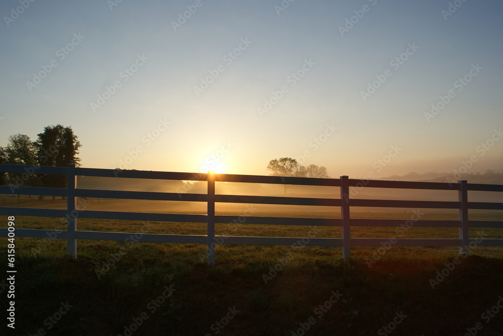Sunrise at a white picket fence ranch in Georgia
