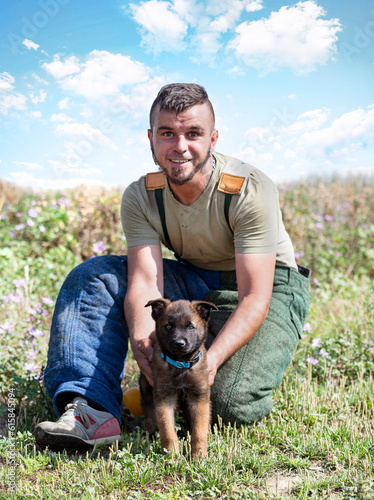 puppy belgian shepherd and owner