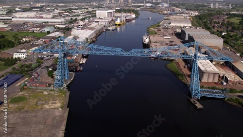 Drone flies slowly back from Transporter Bridge at height. Shot on a sunny spring morning in Middlesbrough  photo