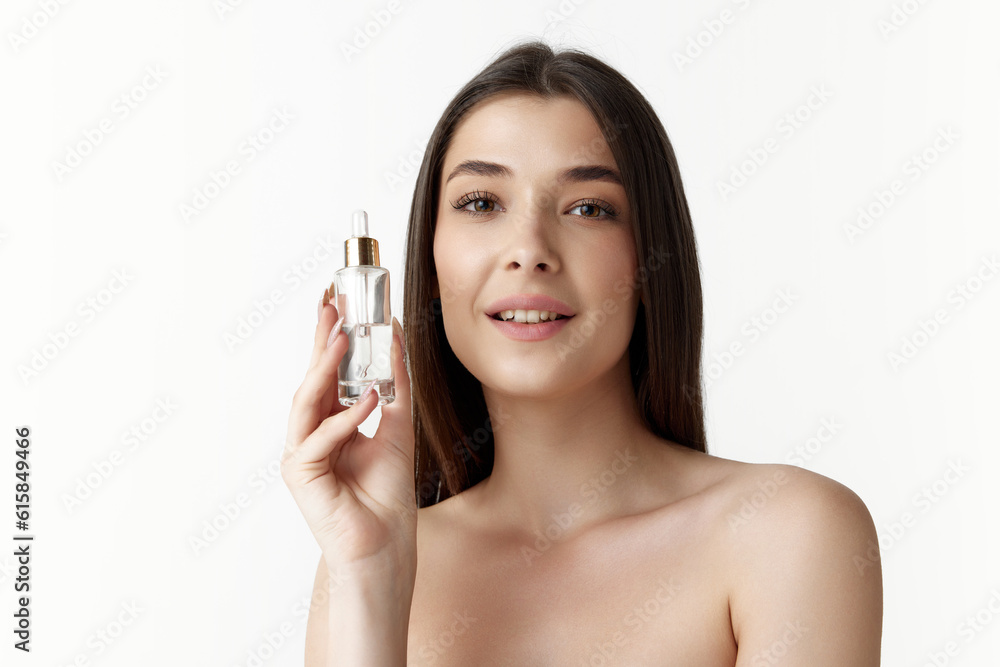 Portrait of beautiful, attractive young woman taking care after skin condition with face organic serum on white studio background. Concept of female beauty, body and skincare, cosmetology, health, ad Portrait of beautiful, attractive young woman taking care after skin condition with face organic serum on white studio background. Concept of female beauty, body and skincare, cosmetology, health, ad