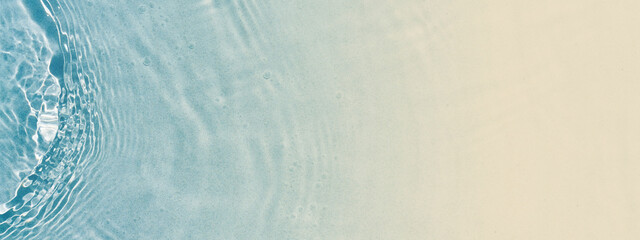 abstract sand beach from above with light blue transparent water wave and sun lights, summer vacation background concept banner with copy space, natural beauty spa outdoors