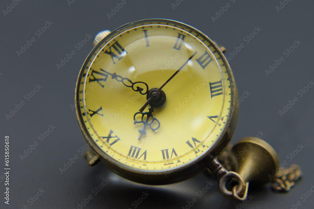 An old pocket watch on a dark gray background