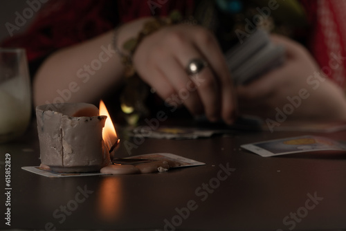 woman fortune-telling on cards, predicting the future, ritual at night, and mystical symbols.