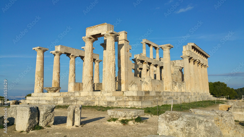 Greek ruins at the Temple of Aphaia on the island of Egina (Saronic Islands Aegean Sea) ancient roman columns, blue sky golden hour soft light (goddess monument) historic remains, Greece Mediterranean