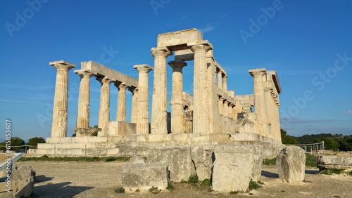 Greek ruins at the Temple of Aphaia on the island of Egina (Saronic Islands Aegean Sea) ancient roman columns, blue sky golden hour soft light (goddess monument) historic remains, Greece Mediterranean photo
