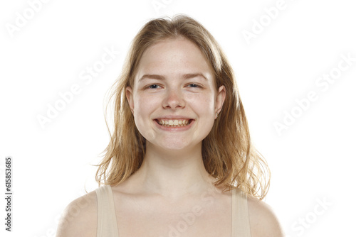 Portrait of young beautiful smiling blonde woman with no makeup on white background