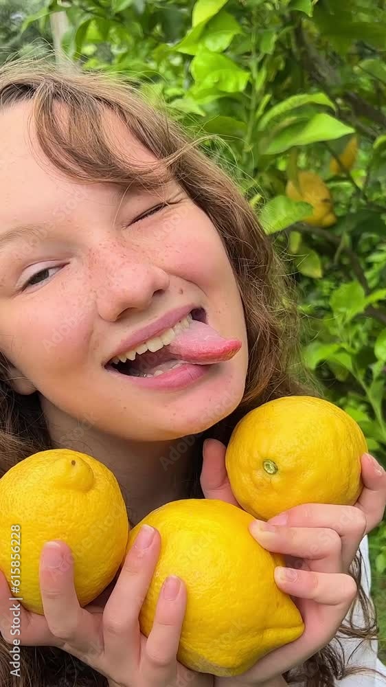 girl teenager have fun dancing smiles and laughs against the backdrop of a lemon tree in her hands she has lemons she fools around with them. High quality 4k footage girl teenager have fun dancing smiles and laughs against the backdrop of a lemon tree in her hands she has lemons she fools around with them. High quality 4k footage