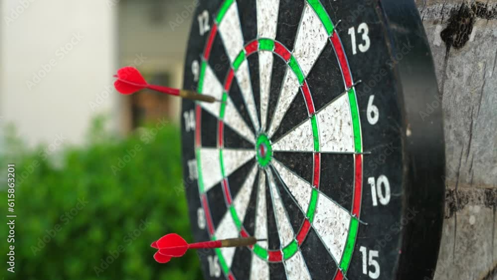 Close-up of red darts throw aim in the center on the tree. A target or blunder Close-up of red darts throw aim in the center on the tree. A target or blunder